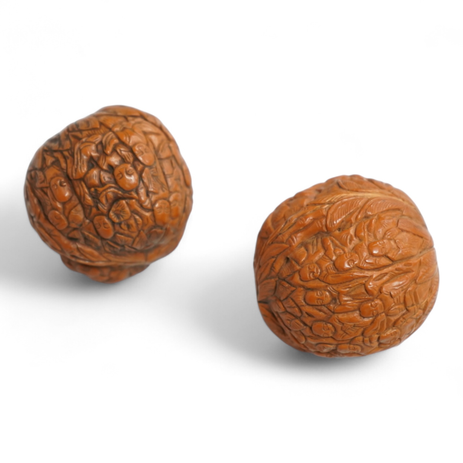 Two Chinese carved walnuts, approximately 4cm in diameter